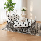 White bed andblack polka dots