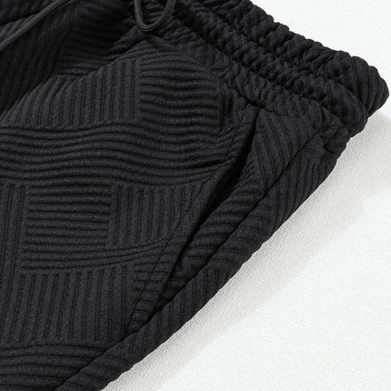 Sophisticated Black Textured Lounge Set with Long Sleeve Top and Adjustable Shorts