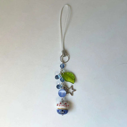 Charming Blue Cat Guardian Phone Accessory | Artisan Keychain with Leaf Detail - Très Elite