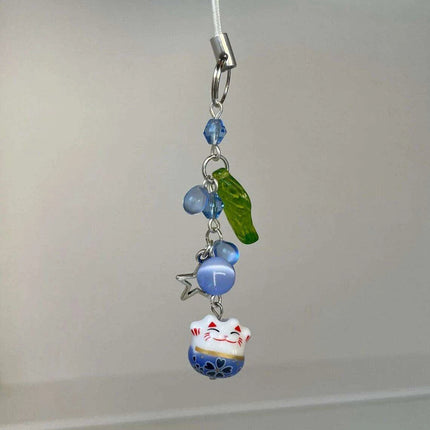 Charming Blue Cat Guardian Phone Accessory | Artisan Keychain with Leaf Detail - Très Elite