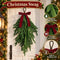 Artificial Norfolk pine Christmas swag with red bow, hanging loop and close-up details on a door
