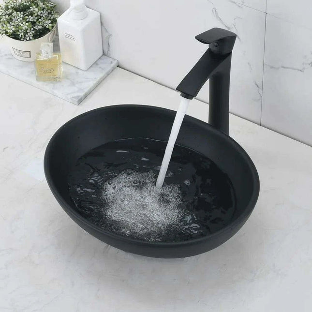 Elegant Oval Ceramic Sink Ensemble with Black Faucet and Stainless Steel Drain