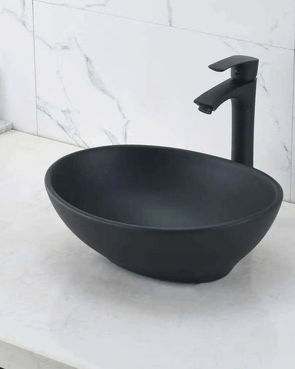 Elegant Oval Ceramic Sink Ensemble with Black Faucet and Stainless Steel Drain