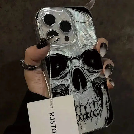 Close-up of black and white skull artwork on a clear-edged iPhone case held in one hand