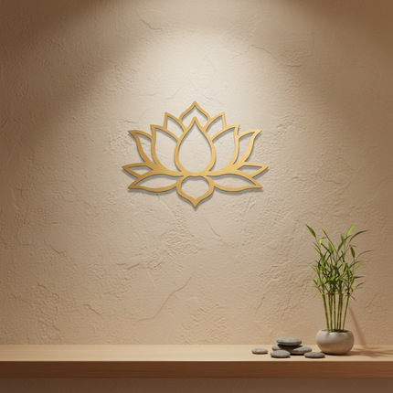A gold metal lotus wall art piece mounted on a textured beige wall above a wooden shelf with a small potted plant and stones.