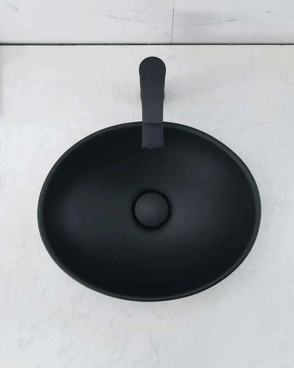 Elegant Oval Ceramic Sink Ensemble with Black Faucet and Stainless Steel Drain