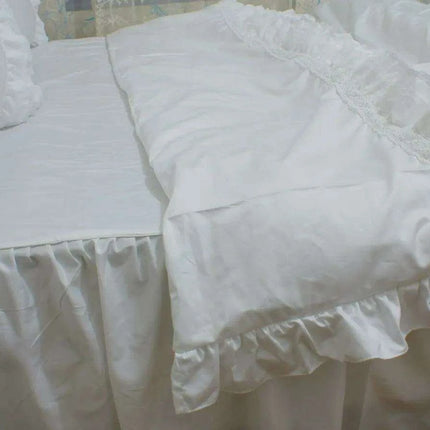 Sophisticated White Cotton Bedding Collection with Lace Detailing and Embroidered Trimmings..