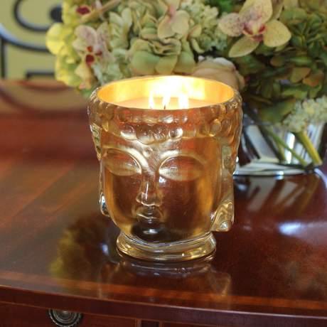 Luxurious 24K Gold Glass Buddha Head Candle with Ambrette and Sandalwood Fragrance Notes