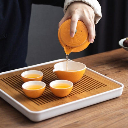 Elegant Orange Ceramic Travel Tea Set: Teapot, Cups, and Pitcher for On-the-Go Tea Lovers