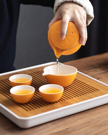Elegant Orange Ceramic Travel Tea Set: Teapot, Cups, and Pitcher for On-the-Go Tea Lovers