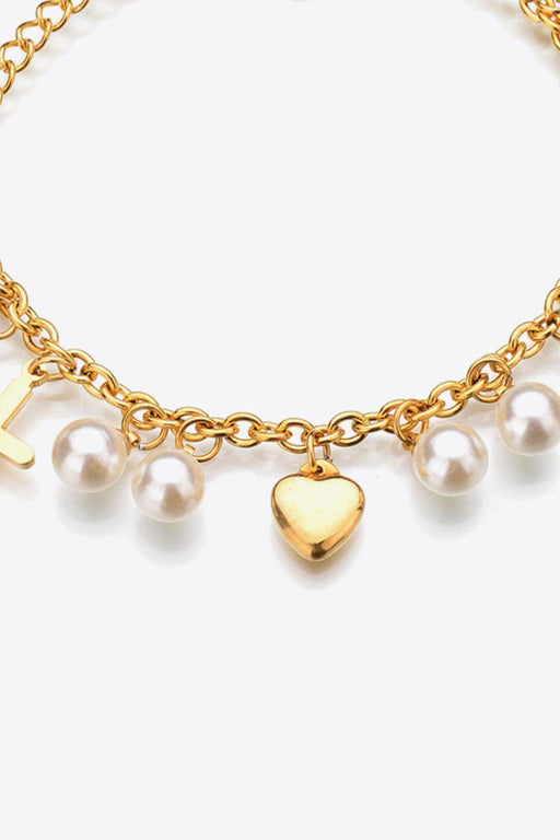 Elegant Stainless Steel Bracelet with Heart Cross and Pearl Accent